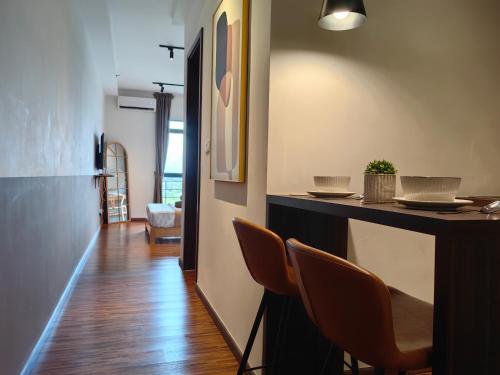 a room with a bar with chairs and a counter at Near Airport K Avenue Family Room in Donggongon