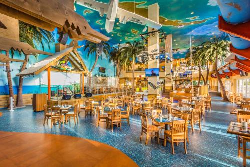 a restaurant with tables and chairs and a ceiling filled with paintings at Margaritaville Hollywood Beach Resort in Hollywood