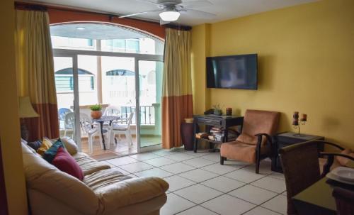 a living room with a couch and a tv at Tiara Sands 302 in Mazatlán