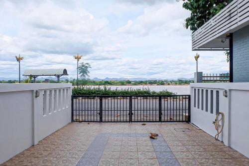 a gate to a house with a view of the water at บ้านเลียบโขง@นครพนม in Nakhon Phanom