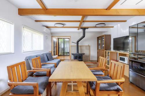 a living room with a wooden table and chairs at Mubean in Nara