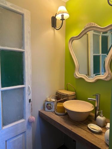 a bathroom with a sink and a mirror at Cottage Zen in Paysandú
