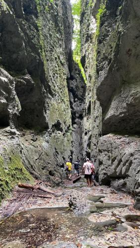 a group of people walking through a rocky canyon at Lainkalogos Glamping in Rabia