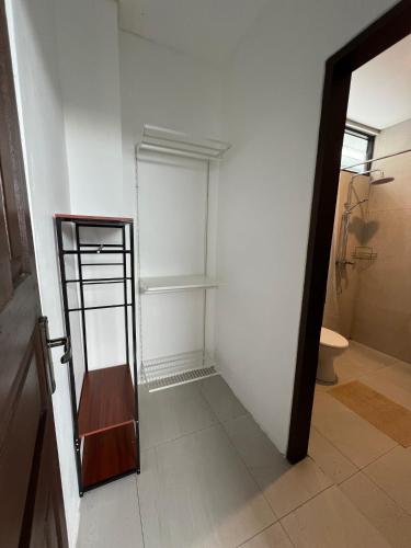 a bathroom with a toilet and a shelf in a room at Villa Tres Adam in Canggu
