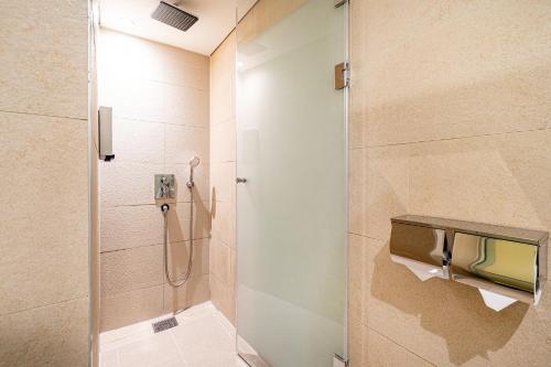 a bathroom with a shower with a glass door at SimpleStay Hotel in Jongno in Seoul