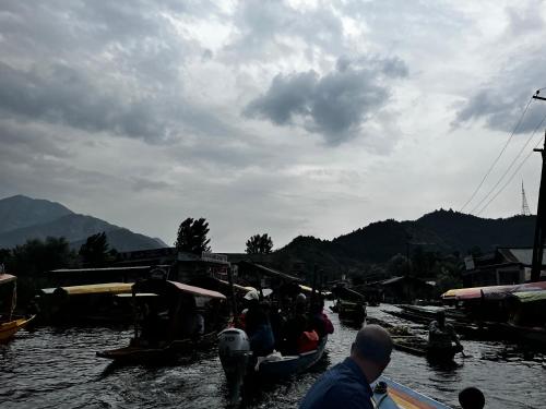 a group of people in boats on a river at Highland Queen Houseboat in Srinagar