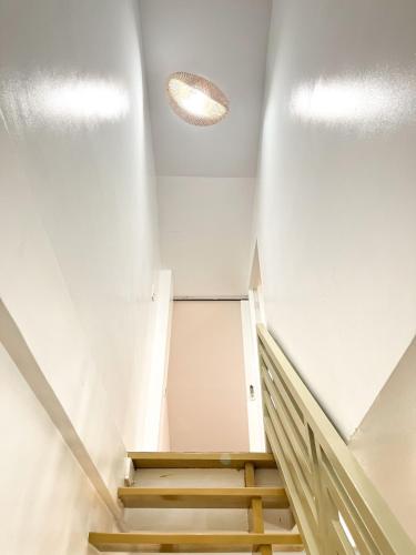 a staircase in a building with a white ceiling at Up To 13 PAX near Clark Speedway & Aqua Planet in Angeles