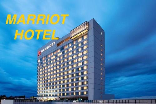 a marriott hotel with a sign on top of it at Up To 13 PAX near Clark Speedway & Aqua Planet in Angeles