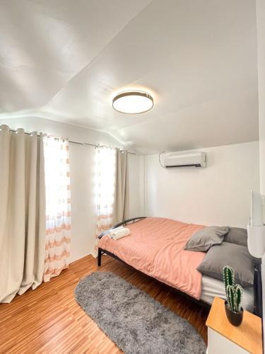 a bedroom with a bed and a window at Up To 13 PAX near Clark Speedway & Aqua Planet in Angeles