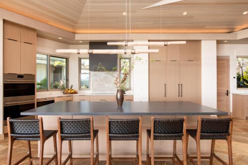 a kitchen with a large table and chairs at Hale 'O Ka La in Hapuna Beach