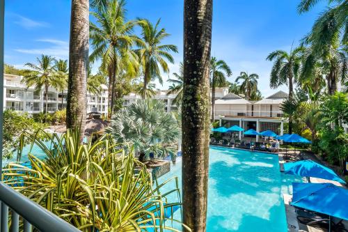a view of the pool from the balcony of a resort at Private Beach Club Apartment in Building 2 in Palm Cove