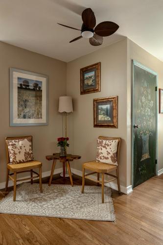 a living room with two chairs and a ceiling fan at Blair House Inn and Spa in Wimberley