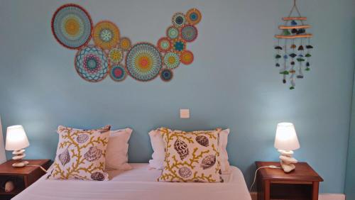 a bedroom with a bed with two night stands and two lamps at sweet island studio ocean in Rivière Noire