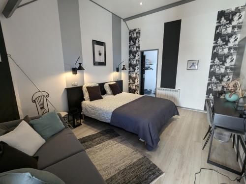 a bedroom with a bed and a couch at Maison de charme avec terrasse et jardin clos à Messas - FR-1-590-568 in Messas