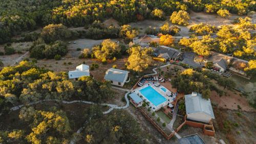 an aerial view of a home with a pool and trees at Blair House Inn and Spa in Wimberley