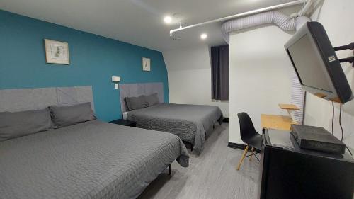 Postel nebo postele na pokoji v ubytování APD HOTEL