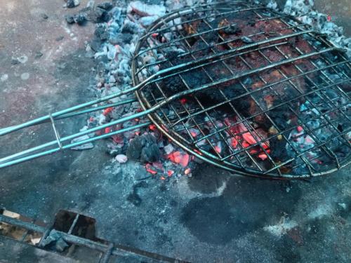a grill with a bunch of trash on the ground at God's gift in Devikolam