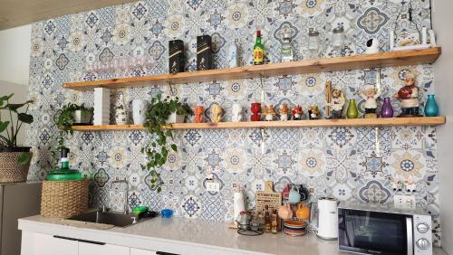 a kitchen with a counter with a tile wall at Nazville vacation home in Pasig