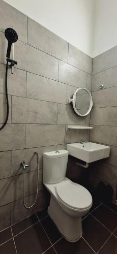 a bathroom with a toilet and a sink and a mirror at Ipoh Meru Landed Homestay TropiCasa 28 in Ipoh