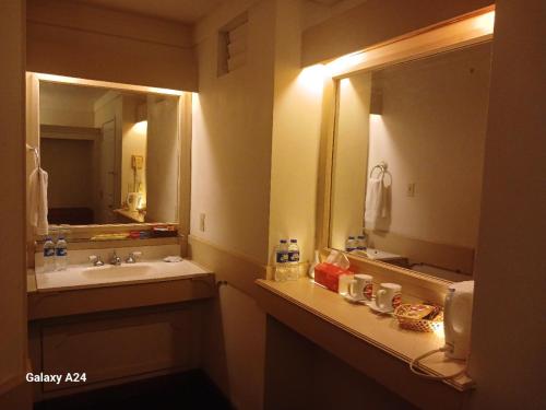 a bathroom with a sink and a mirror at Yap Pacific Dive Resort in Yaptown
