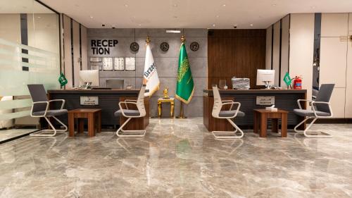 a lobby of a hotel with chairs and a counter at Brzeen Hotel Riyadh in Riyadh