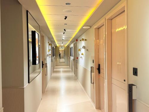 a hallway of a hospital with a long corridor of halls at Hotel Fun Regency Motera Ahmadabad in Ahmedabad