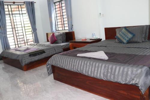 Ένα ή περισσότερα κρεβάτια σε δωμάτιο στο AHHA Bungalow Kampot