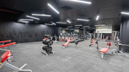 a gym with a bunch of equipment in a room at Brzeen Hotel Riyadh in Riyadh