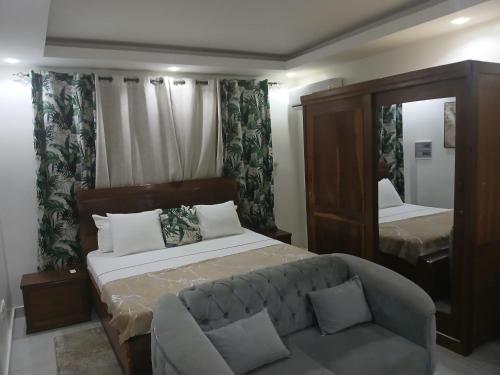 a living room with a bed and a couch at RESIDENCE FABY 1 in Dakar