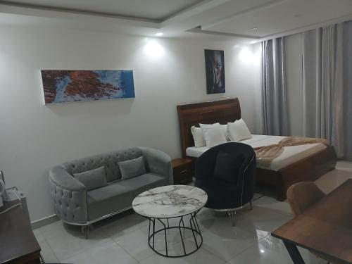 a hotel room with a bed and a couch at RESIDENCE FABY 1 in Dakar