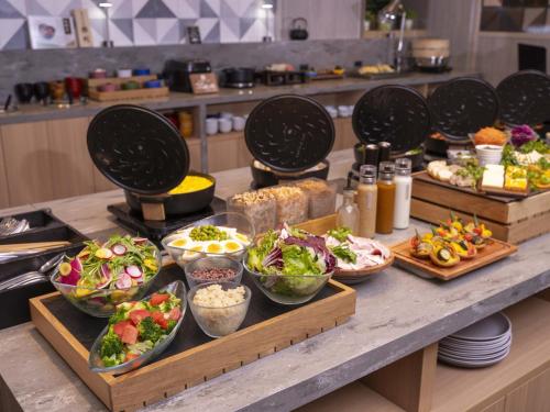a buffet with bowls of food on a table at Hotel Forza Kyoto Shijo Kawaramachi in Kyoto
