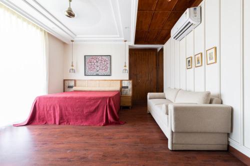 a living room with a bed and a couch at 4bhk-Villa at dlf valley township Panchkula in Panchkula