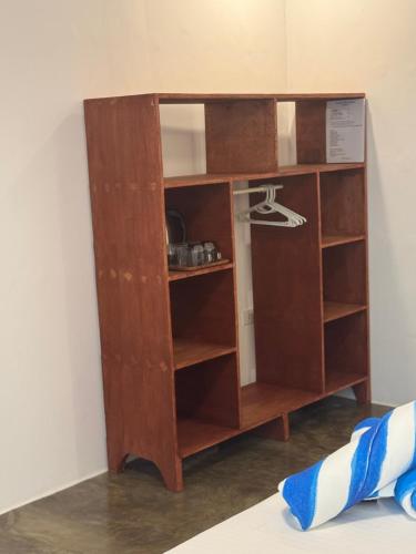 a wooden book shelf in a room at NUTMEG Cottage Siargao- Private room in General Luna