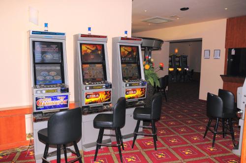 a row of video game machines in a room at Hotel Fontana in Buzet