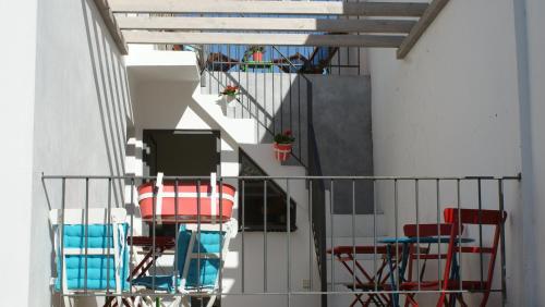 a group of chairs and tables on a balcony at Casas da Formosa - Casa do Postigo in Tavira