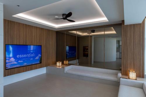 a living room with a ceiling fan and a tv at Meomulda Ga Gwangan Poolvilla in Busan