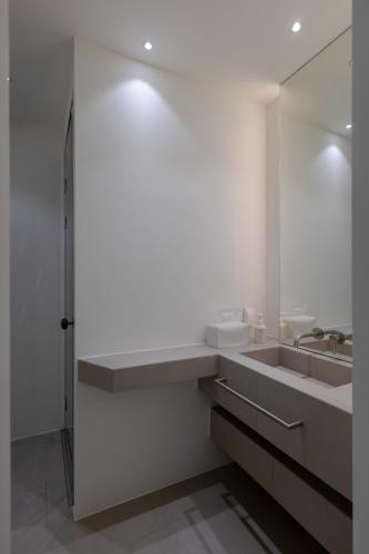 a bathroom with a sink and a mirror at Meomulda Ga Gwangan Poolvilla in Busan