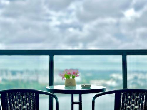a table with a vase of flowers on top at R&F Seine Region in Johor Bahru