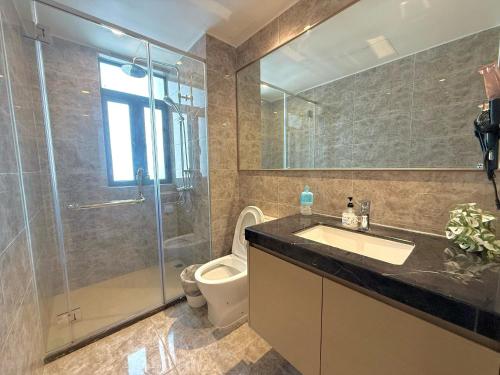a bathroom with a toilet and a sink and a shower at R&F Seine Region in Johor Bahru