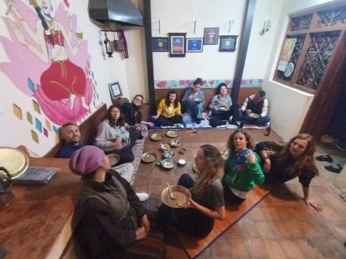 a group of people sitting on the floor in a room at Sanu House in Pātan