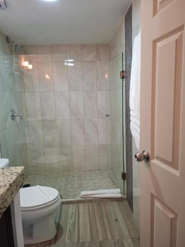 a bathroom with a shower and a toilet at Condominio Xaman Ha 7107 in Playa del Carmen