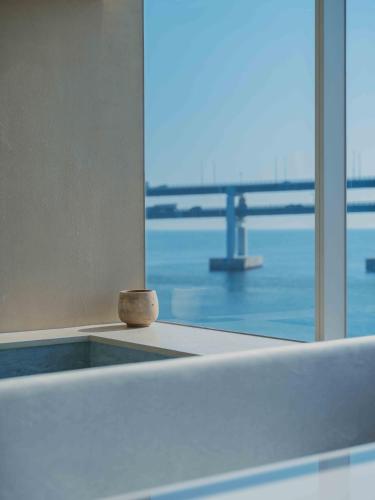 a room with a window with a view of a bridge at Meomulda Gwangalli Gamsung in Busan