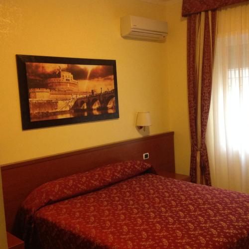 a bedroom with a bed and a painting on the wall at Guglielmo Marconi House in Rome