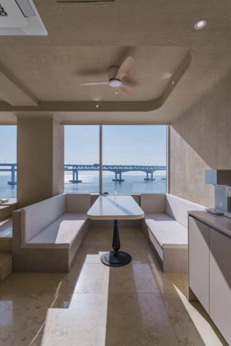 a living room with couches and a table and a bridge at Meomulda Gwangalli Gamsung in Busan