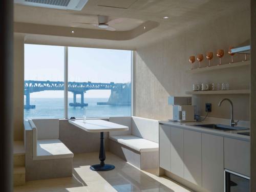 a kitchen with a view of a bridge at Meomulda Gwangalli Gamsung in Busan