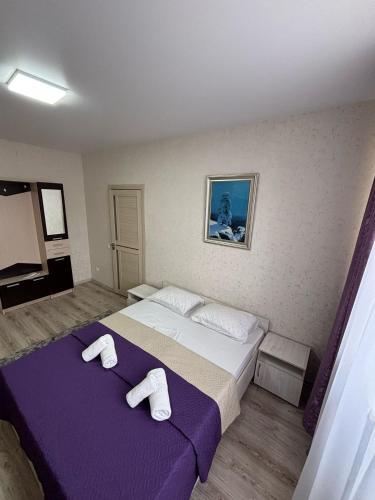 a bedroom with two beds with towels on them at Гостиница ,,Меркурий и К,, in Astana
