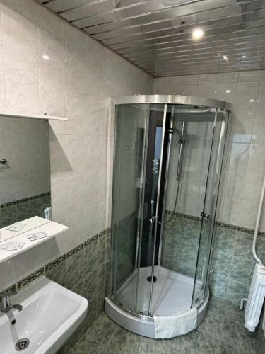 a bathroom with a shower and a sink at Гостиница ,,Меркурий и К,, in Astana