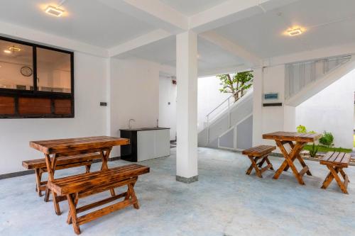 a room with wooden tables and benches at Pleasure Villa in Matara