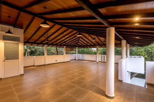 a large room with a wooden ceiling and a wooden floor at Pleasure Villa in Matara