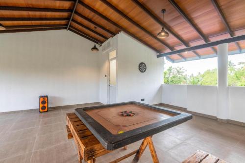 a ping pong table in the middle of a room at Pleasure Villa in Matara